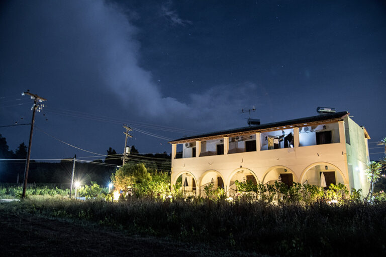 Villa Maria Perivoli lit at night, seen from the garden, Corfu