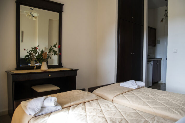 Studio interior with dressing table, wardrobe and kitchenette at Villa Maria Perivoli